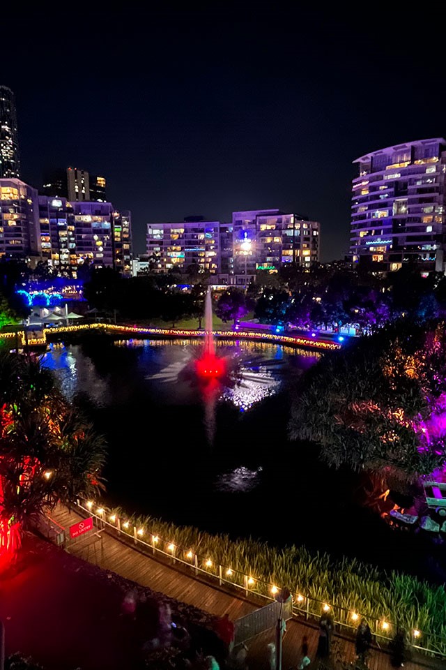 Lake featuring a fountain uplit with coloured lights