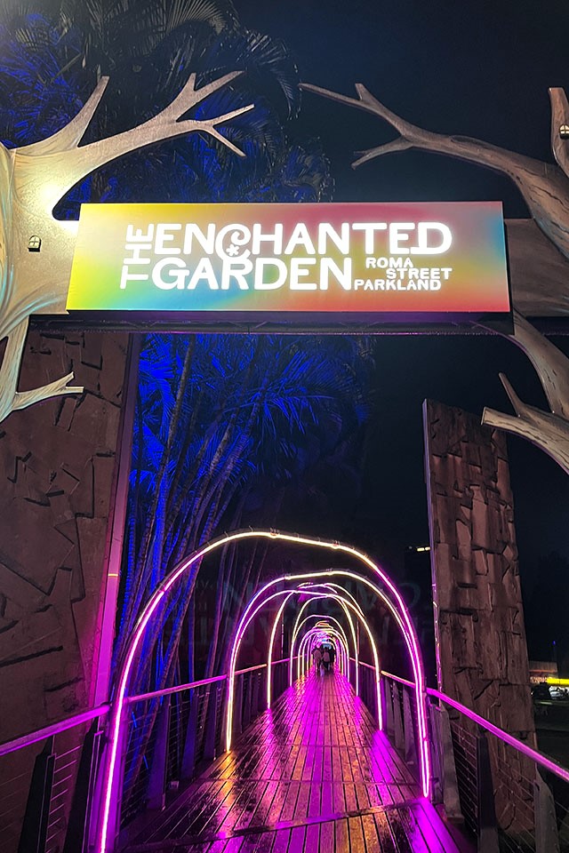 The Enchanted Garden entry sign leading to Allee Bridge with coloured archway