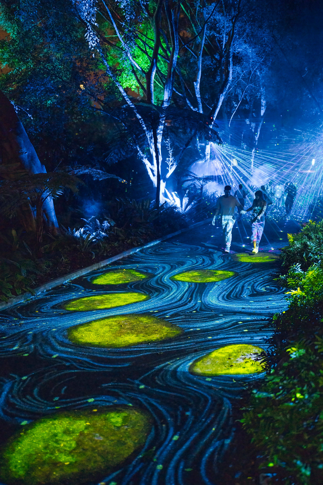 Blue light projections imitating flowing water with yellow stepping stones